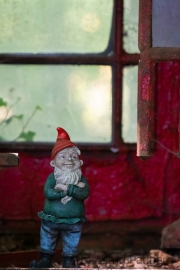 Garden gnome (Gartenzwerg) in telephone booth